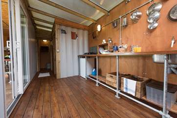 Rusty's spacious kitchen has a sink, gas-burner and fridge with the cloakroom and shower-room set further along the back on the extension.