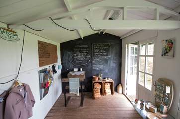 The honesty-shop with fridge and freezer containing a variety of locally produced goods.