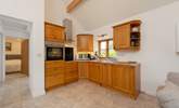 The kitchen is fitted around the corner of the open plan living space. - Thumbnail Image