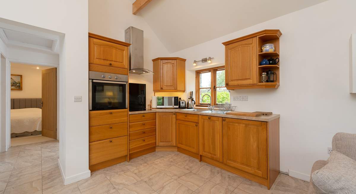 The kitchen is fitted around the corner of the open plan living space.