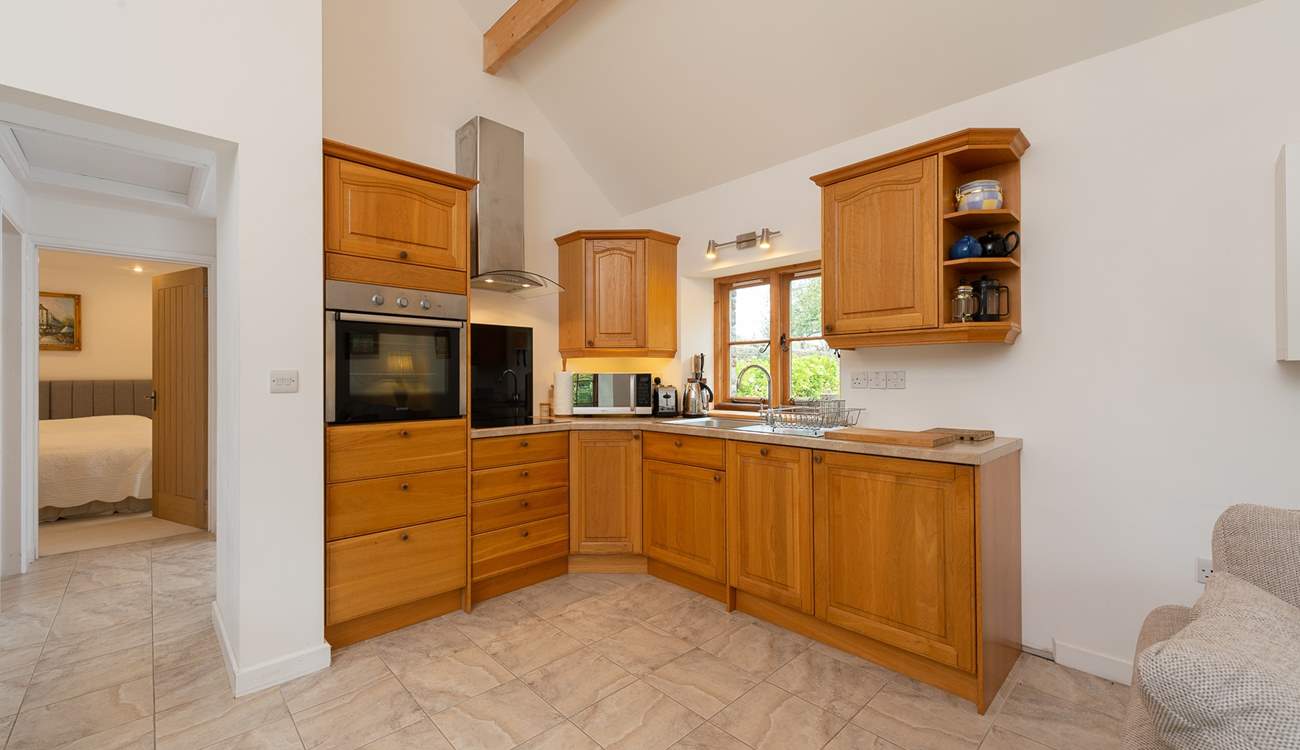 The kitchen is fitted around the corner of the open plan living space.