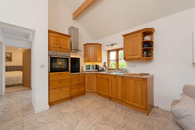 The kitchen is fitted around the corner of the open plan living space.