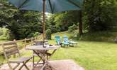 The cottage has a little patio as well as the lovely open area of lawn. - Thumbnail Image