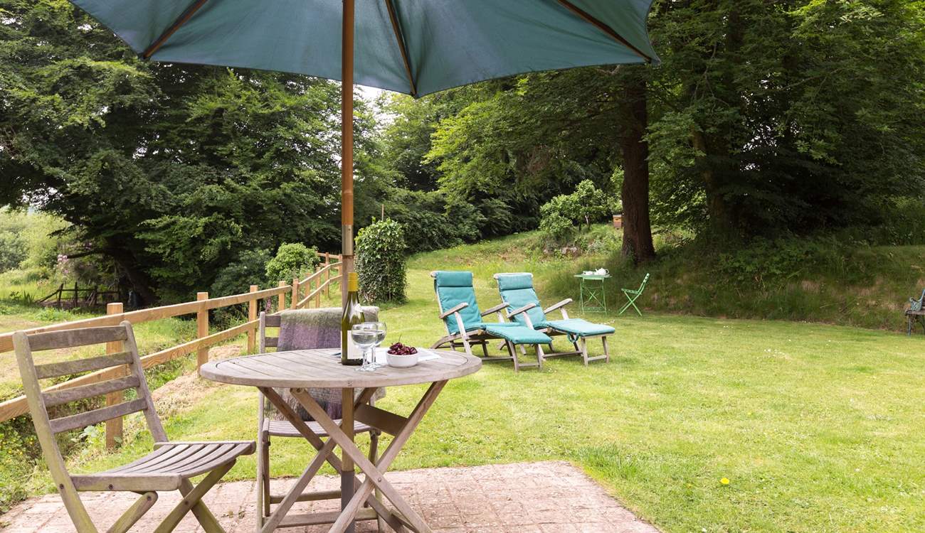 The cottage has a little patio as well as the lovely open area of lawn.