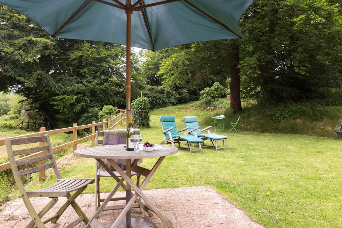 The cottage has a little patio as well as the lovely open area of lawn.