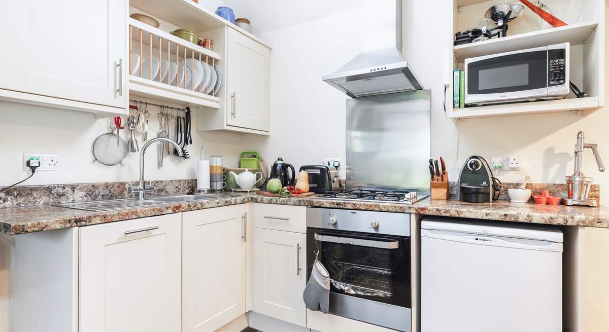 There is a kitchen tucked into one corner of the open plan living space. Please note, the gas hob was replaced with an induction hob in May 2024 (new photos available soon).