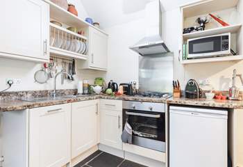 There is a kitchen tucked into one corner of the open plan living space.