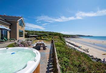 Complete joy relaxing in the hot tub with the sandy beach on your doorstep.