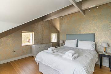 The double bed on the first floor with sea views and an en suite bathroom.