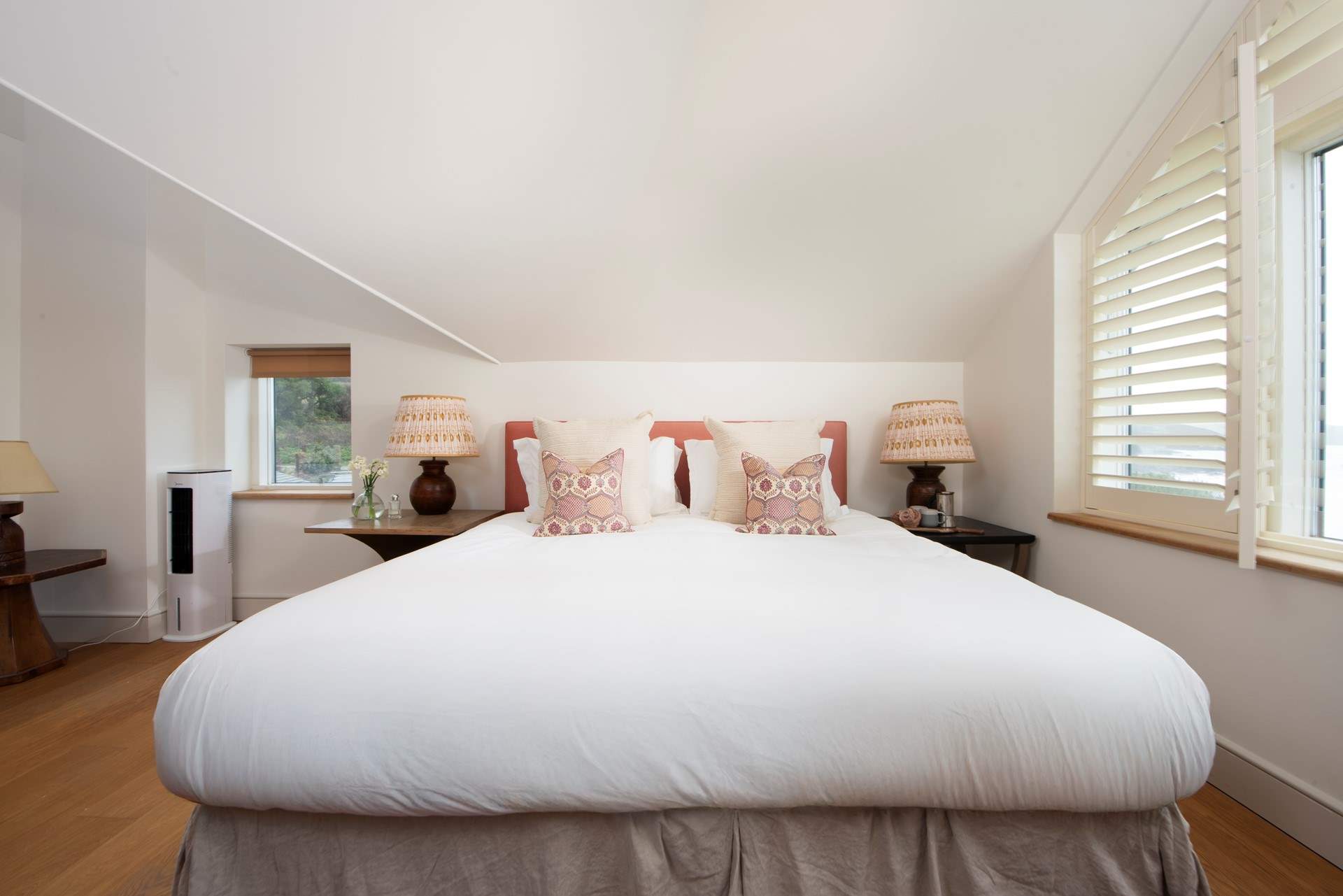 The inviting super-king bed in bedroom 4, an elegant space with stunning sea views.