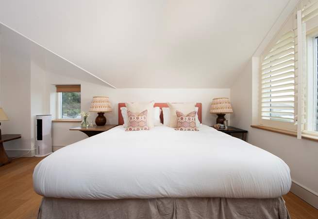 The inviting super-king bed in bedroom 4, an elegant space with stunning sea views.