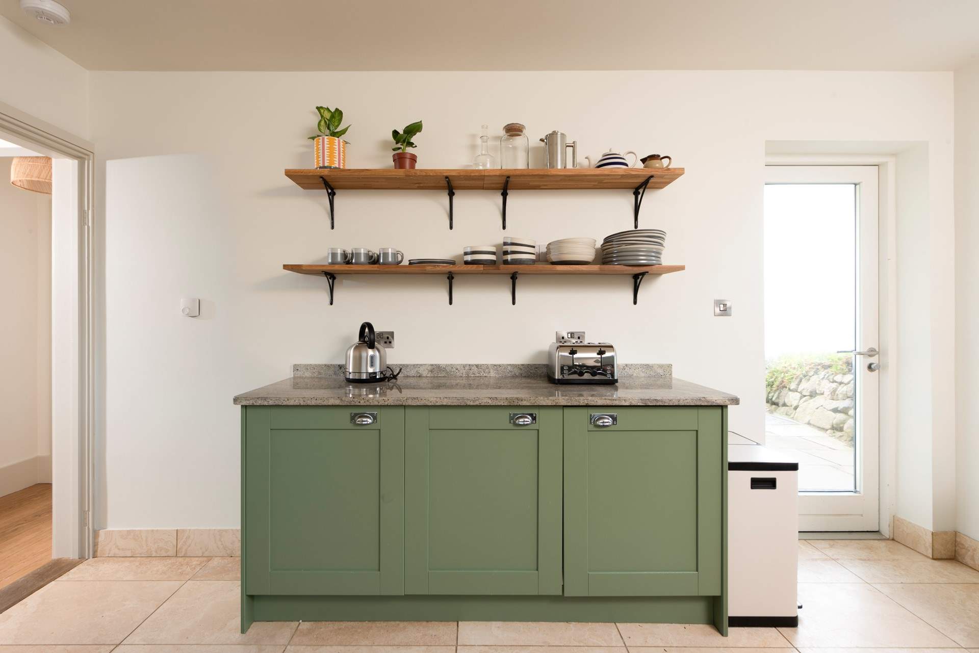 The back door leads out to the gardens and hot tub.