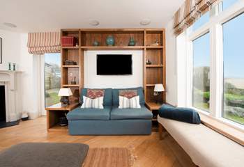 A welcoming room with windows that flood the space with light. Light the cosy wood-burner on chillier evenings.