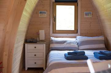 The cosy double bed awaits you after a day of exploring.