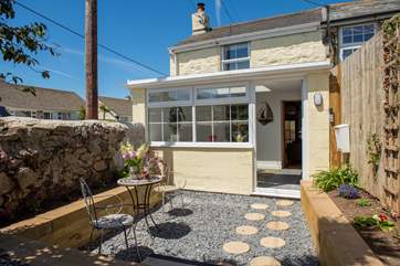 Enter the cottage via the lovely sun-room.