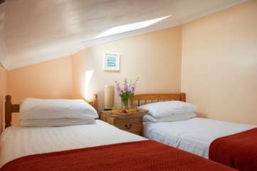 The twin bedroom with its low ceilings and comfortable beds.