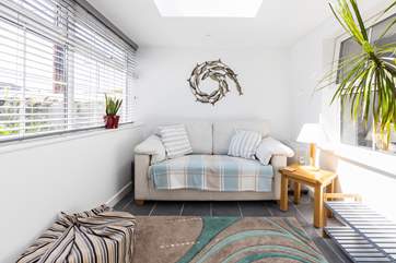The sun-room overlooks the pretty gravelled terrace.