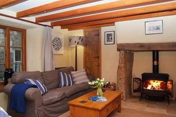 The sofas flank the wood-burner in the sitting-room.