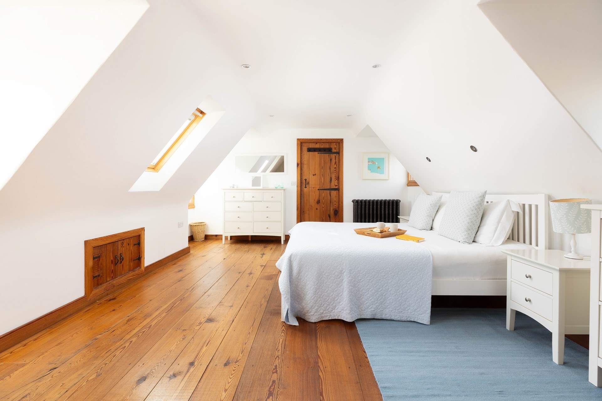 A spacious light main bedroom.