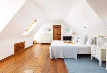 A spacious light main bedroom.