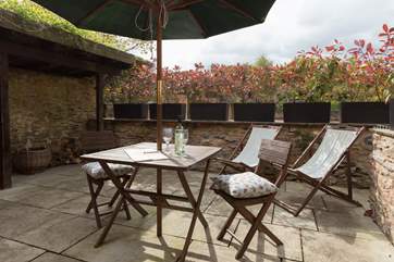 This is another view of the little sitting-out patio at the back of the cottage. Your log store is here too.