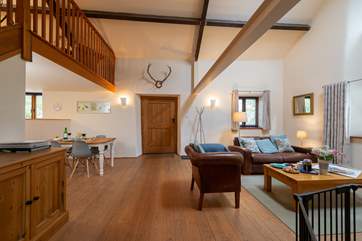 The open plan living space includes a dining area, well equipped kitchen, a utility area and large shower room