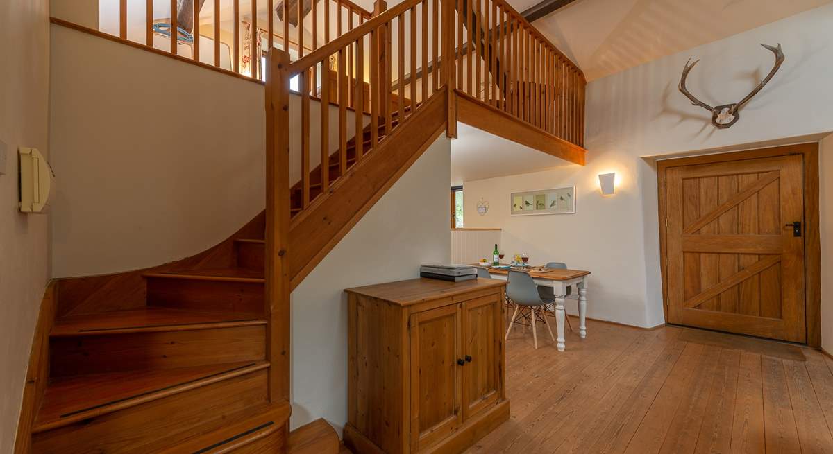 Beautifully crafted wooden stairs lead up to the  mezzanine bedroom area.