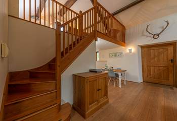 Beautifully crafted wooden stairs lead up to the  mezzanine bedroom area.