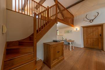 Beautifully crafted wooden stairs lead up to the mezzanine bedroom area.
