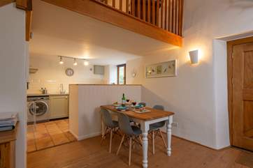 The dining area and kitchen are cleverly separated by this half-wall.