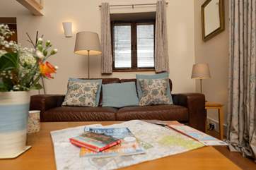 A comfortable sofa and arm chair ensure that you can cosy up by the wood burning stove if you have an out of season break.