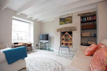 The second sitting-room has a TV and a dolls house.