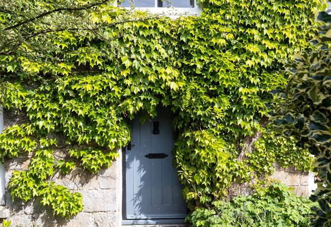 Such a charming entrance to this cottage, set back from the road. There is additional parking outside of the house if needed.