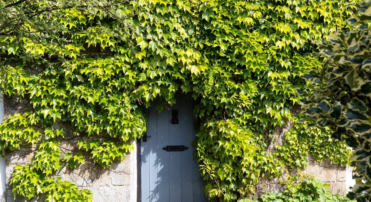 Such a charming entrance to this cottage, set back from the road. There is additional parking outside of the house if needed.
