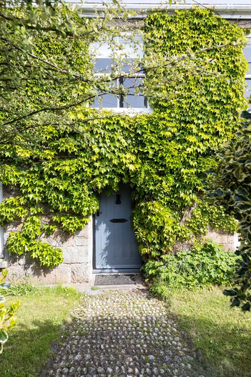 Such a charming entrance to this cottage, set back from the road. There is additional parking outside of the house if needed.