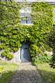 Such a charming entrance to this cottage, set back from the road. There is additional parking outside of the house if needed.