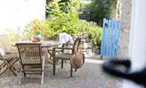 Enjoy dinner in the tranquil rear garden directly from the kitchen door. - Thumbnail Image