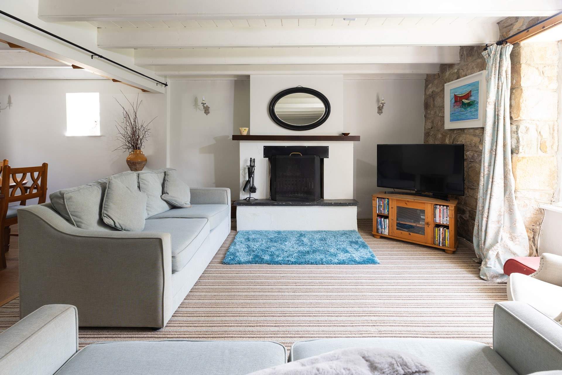 A spacious sitting-room with an open fire.