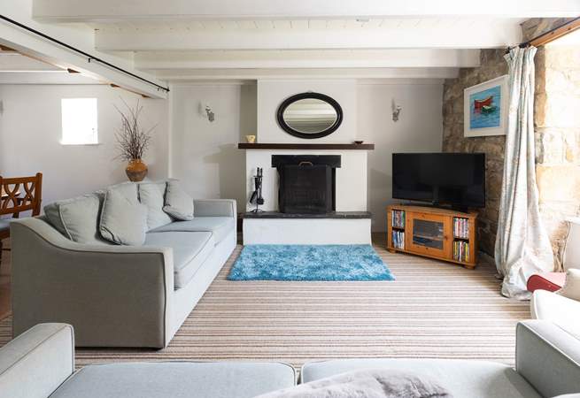 A spacious sitting-room with an open fire.