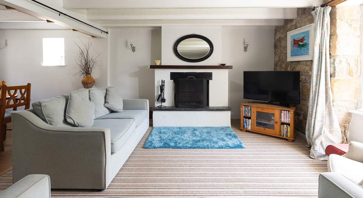 A spacious sitting-room with an open fire.