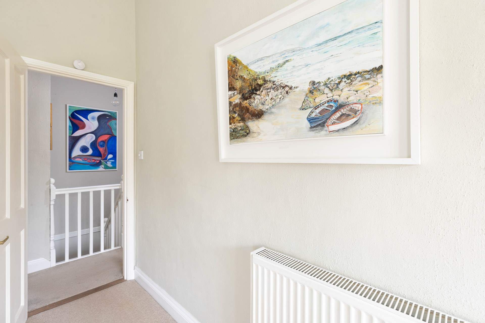 The owners original artwork is shown throughout this lovely cottage.