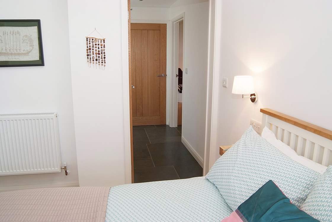 The bedroom leads to the hallway and right into the sitting-room.