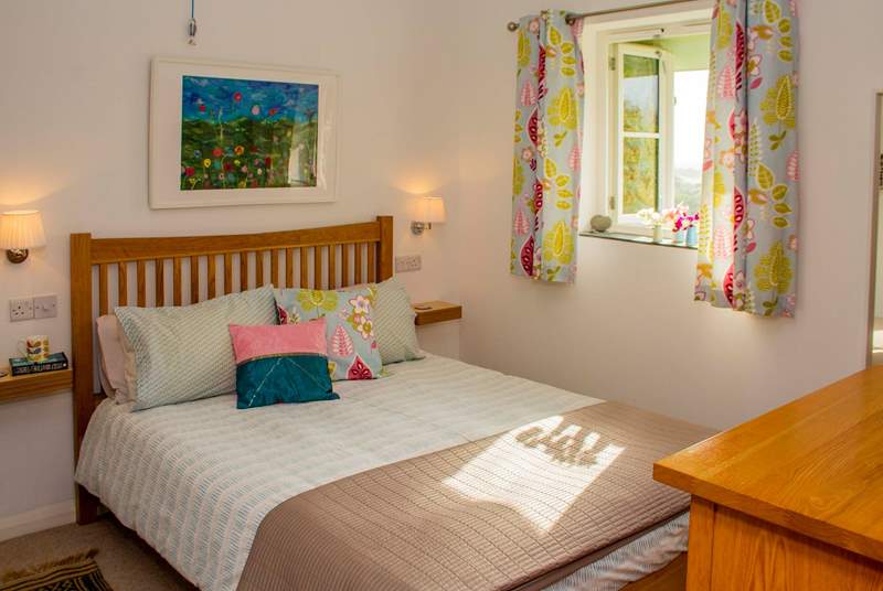 The beautifully furnished bedroom with those wonderful countryside views and en suite shower-room.