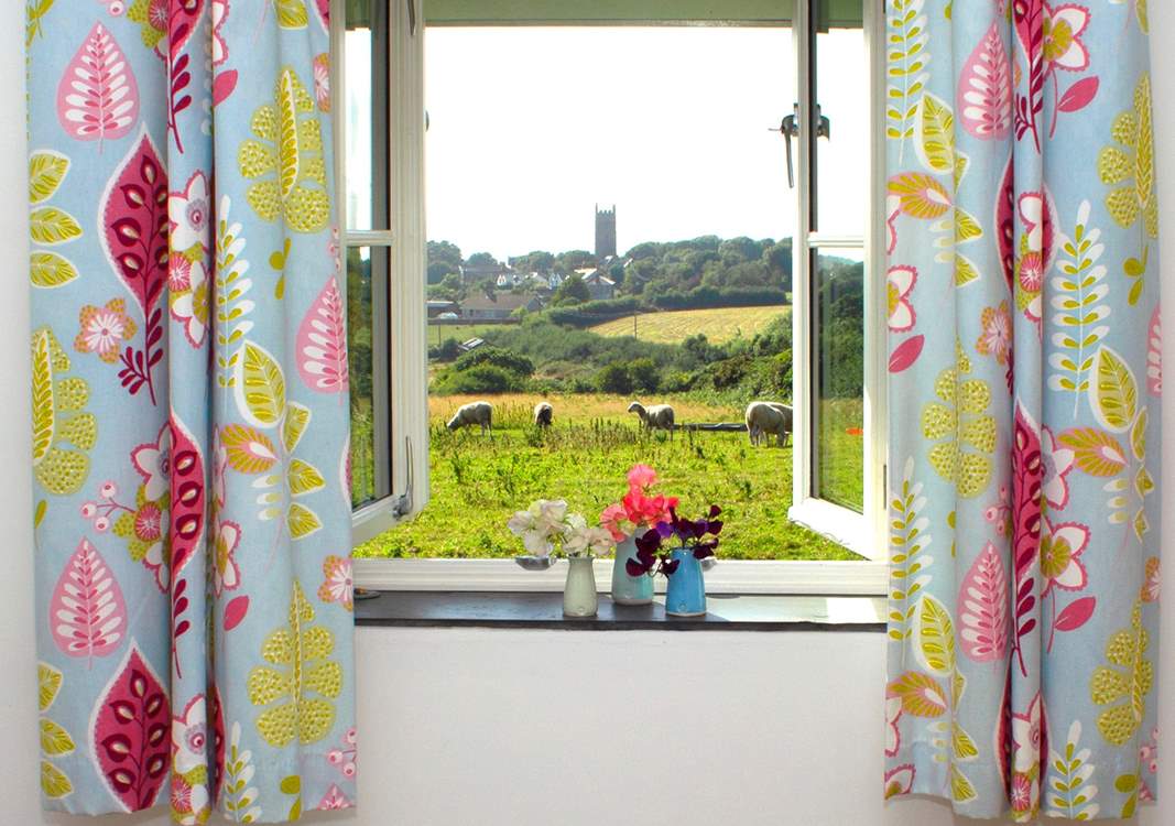 This is the view from your bedroom window across the fields to the village church.