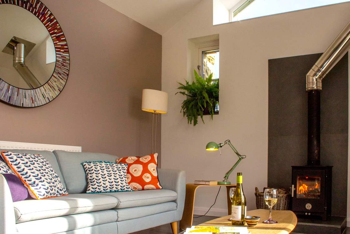 Colourful soft furnishings and muted blues and greens give a relaxed feel.