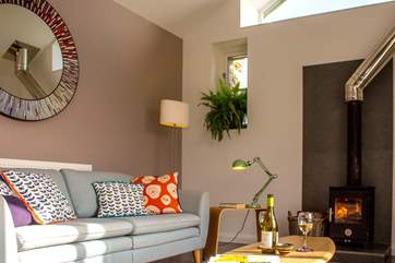 Colourful soft furnishings and muted blues and greens give a relaxed feel.