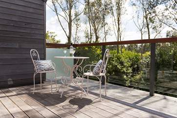 The balcony outside the second sitting-room looks out over the terrace and woodland beyond.