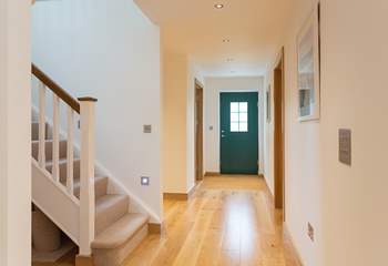 The wide entrance hallway flows seamlessly into the living-room.