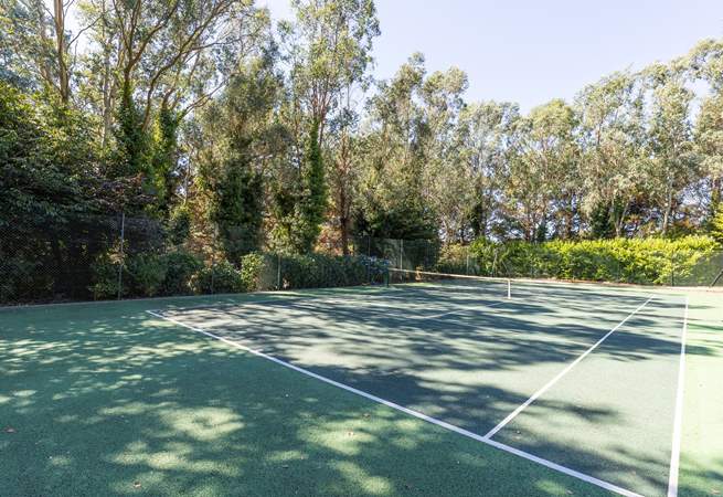 A tennis court and croquet lawn for outdoor fun.