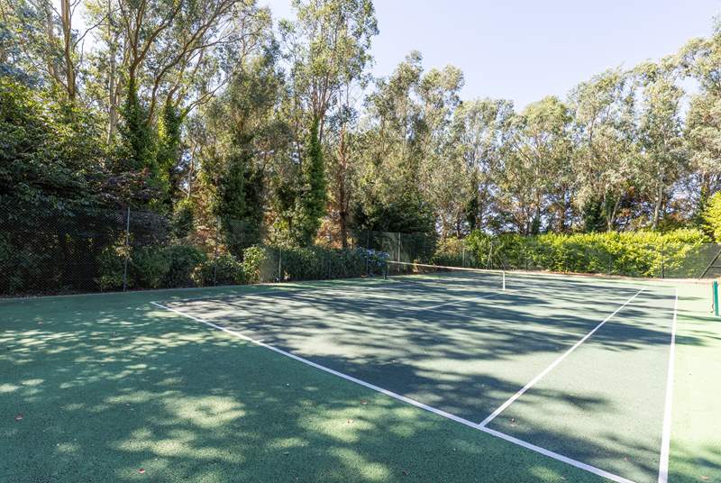 A shared tennis court and croquet lawn for outdoor fun.